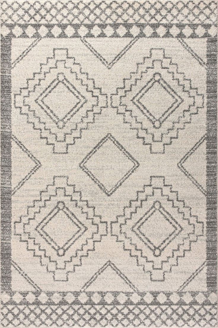 a gray and white rug with diamond shapes