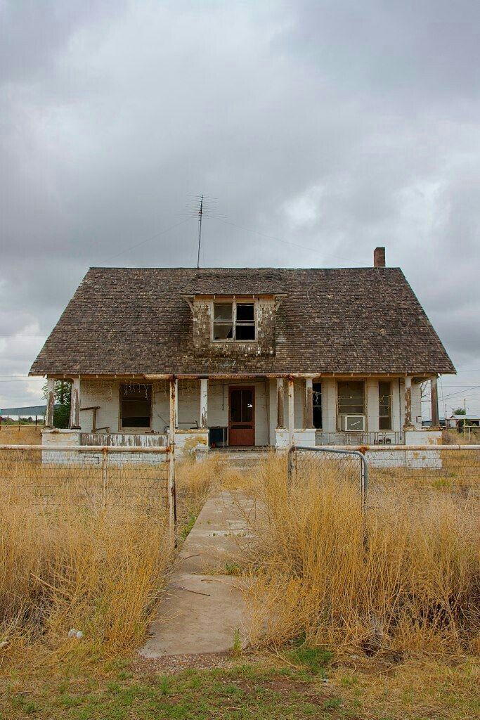 an old run down house in the middle of nowhere