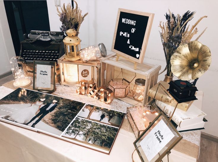 a table topped with pictures and candles on top of it