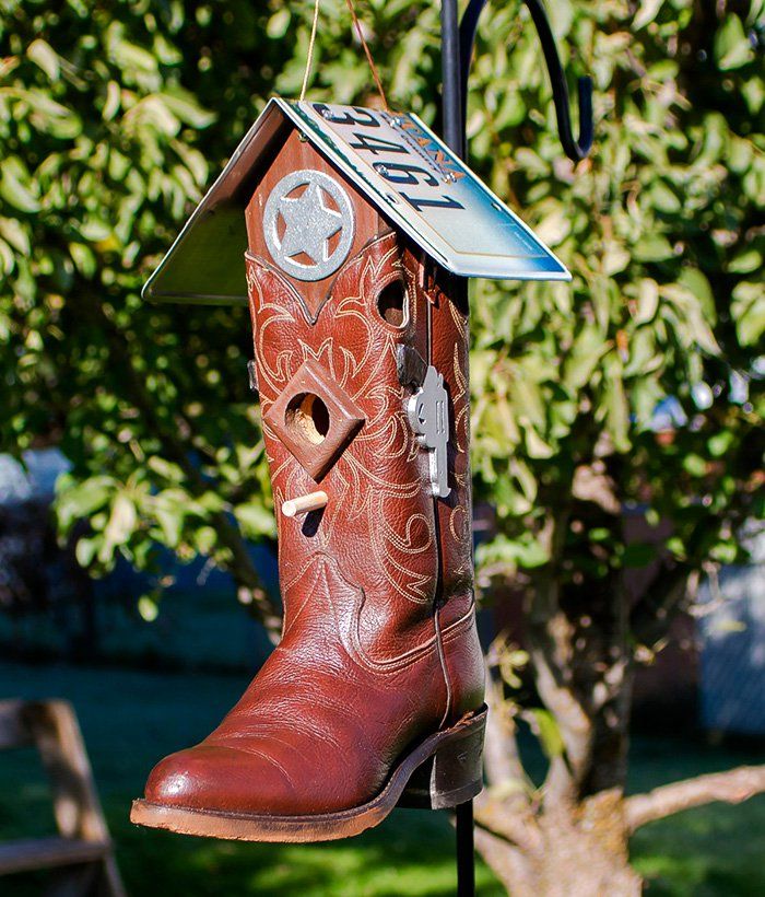 a pair of cowboy boots hanging from a tree