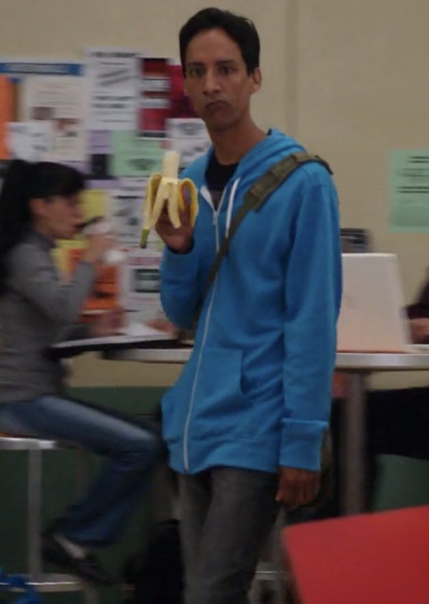 a man holding a banana in his right hand