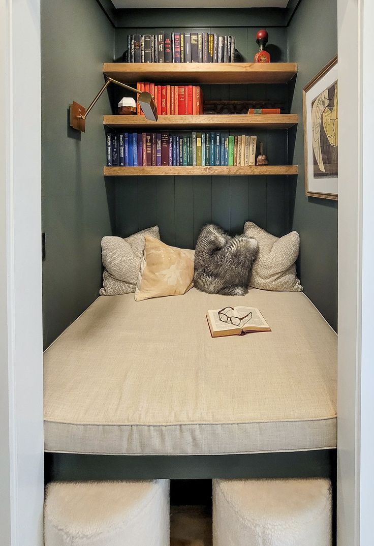 there is a bed in the closet with books on it