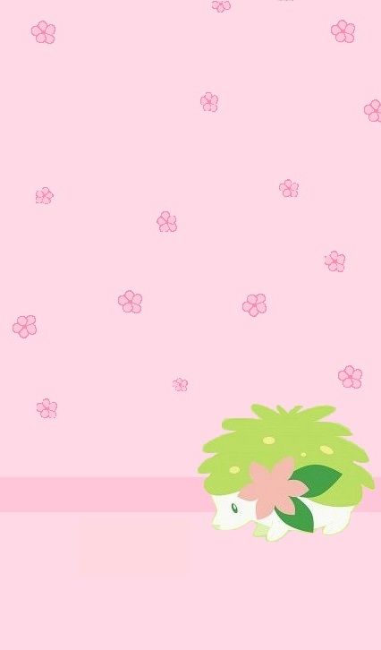 a pink wall with flowers on it and a green plant in the corner next to it