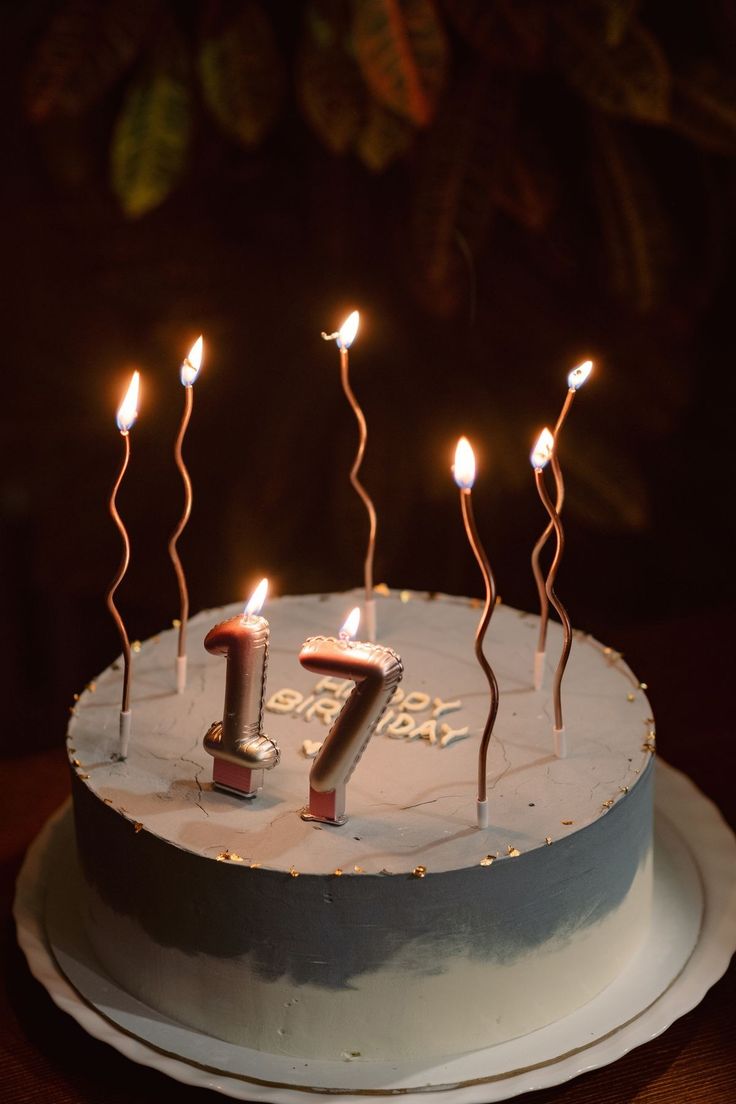 a birthday cake with candles that spell the number seven