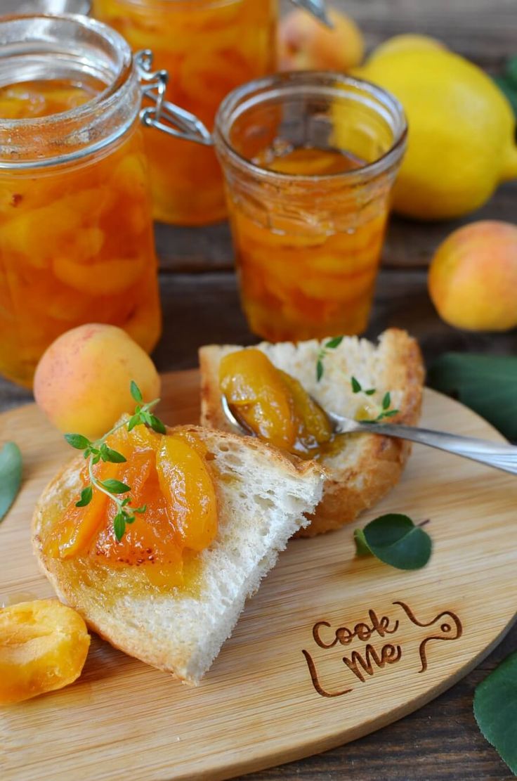 there is a piece of bread with fruit on it and two jars full of jam