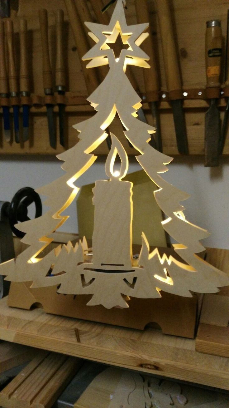 a wooden christmas tree with lights on it