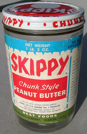 a can of skippy peanut butter sitting on the ground