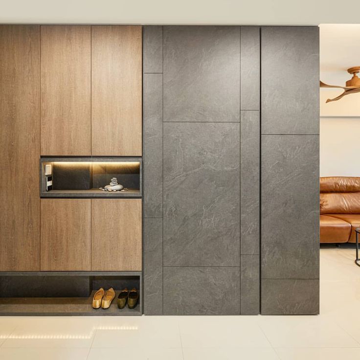 a living room filled with furniture and a fire place next to a wall mounted oven