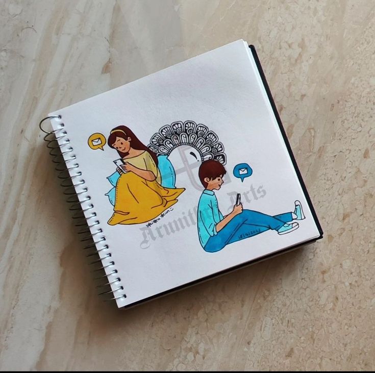 a notebook with an image of a man and woman sitting on the floor next to each other