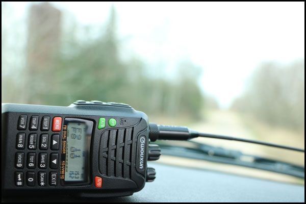 an old cell phone sitting on top of a car dashboard