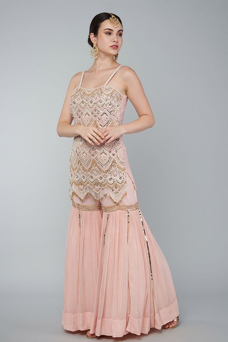 Blush pink embroidered tunic with pearls, zari work in art deco motifs. Comes with gharara and net choker dupatta.
Component: 3
Pattern: Embroidery
Type Of Work: Pearl,zari
Neckline: Sweetheart
Sleeve Type: Sleeveless
Fabric: Georgette,Net
Color: Pink
Other Details: 
Pearl,zari embroidery
Art deco motifs
Occasion: Destination Wedding - Aza Fashions Choker Dupatta, Art Deco Motifs, Zari Embroidery, Zari Work, Pattern Embroidery, Embroidered Tunic, Sweetheart Neck, Pink Pearl, Set For Women