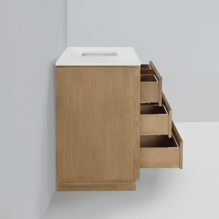 a wooden cabinet with drawers and a white counter top