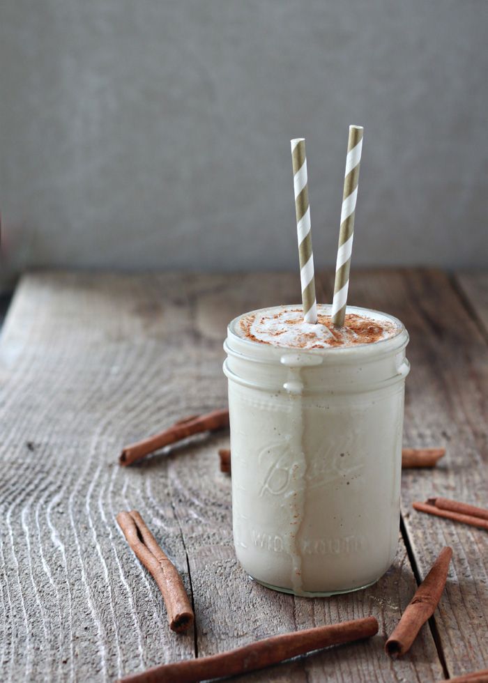 there is a drink with two straws in the cup and cinnamon sticks sticking out of it