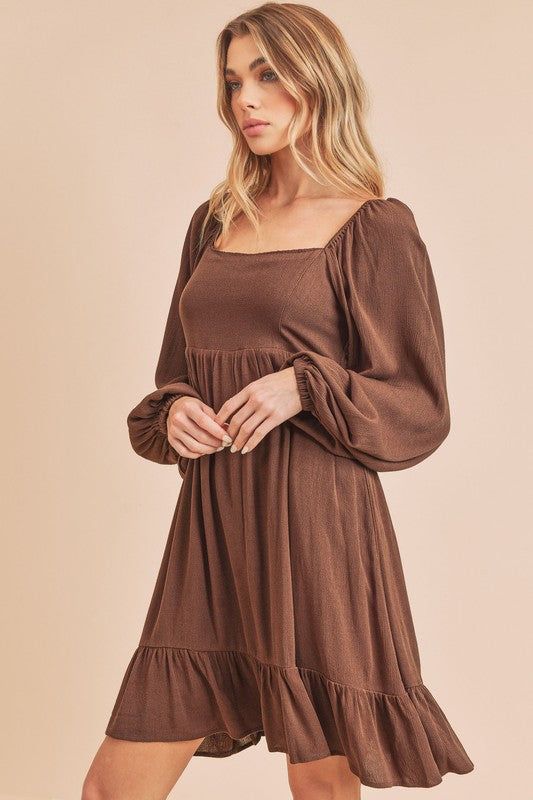 Get your twirl on in our airy textured Taya Dress with a square neckline, tiered through skirt, finished with puff sleeves and smocked back.Fabric Contents: 100% RayonSize Measurement (inch): S: 15.5 (Bust), 13.5 (Waist), 16.5 (Hips), 33.5 (Length) M: 16.0 (Bust), 14.0 (Waist), 17.0 (Hips), 34.0 (Length) Square Neck Puff Sleeve Dress With Ruffles, Solid Puff Sleeve Dress With Ruffles And Square Neck, Square Neck Smocked Bodice Tiered Dress For Brunch, Fall Smocked Dress With Ruffles And Square Neck, Square Neck Tiered Dress With Smocked Back For Brunch, Fall Puff Sleeve Dress With Square Neck, Brown Puff Sleeve Dress With Smocked Bodice, Flowy Puff Sleeve Dress With Square Neck And Ruffles, Tiered Smocked Dress With Ruffle Hem