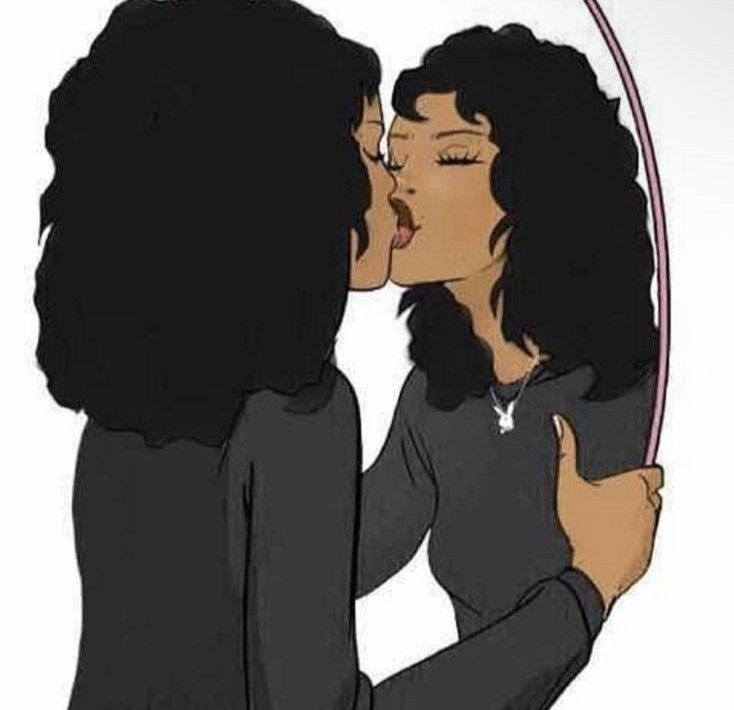 two women are kissing each other in front of a circular mirror with the reflection of them