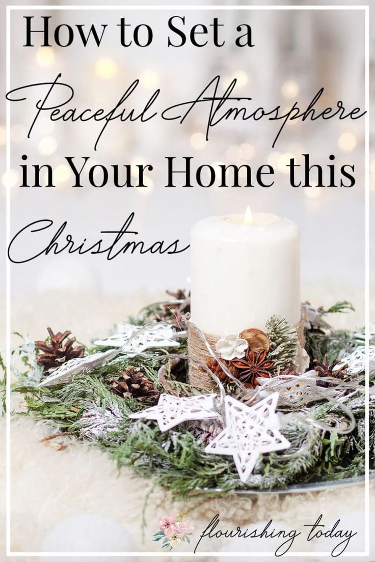 a white candle sitting on top of a christmas wreath