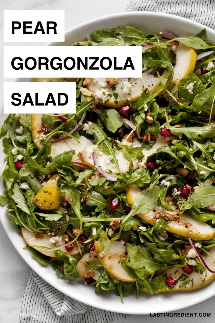 pear gorgonzolo salad with pomegranate and feta cheese on top