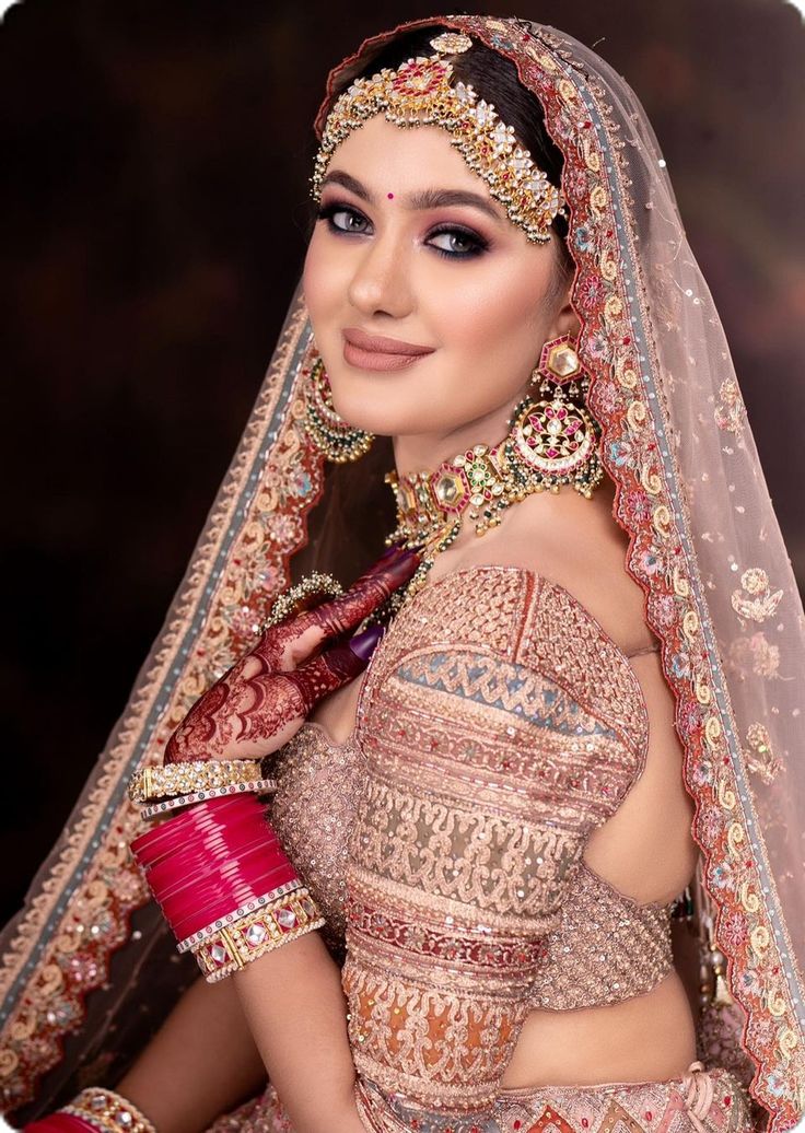 a woman in a bridal outfit posing for the camera