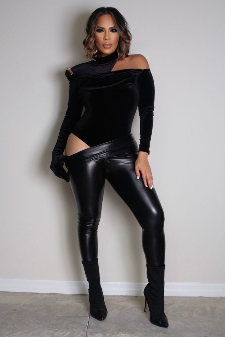 Turn heads this autumn and winter with our Asymmetrical Neck Cut Out Shoulder Velvet Bodysuit. This striking black bodysuit features a bold asymmetrical neckline with an alluring cut-out detail, complemented by a stand collar and thick shoulder pads for added drama. The ruched accents and decorative chain enhance its sophisticated design, while one sleeve includes an attached glove for an extra edge. Made from slightly stretchy knitted fabric, this slim-fit bodysuit ensures a sleek silhouette an Fall Bodysuit, Bandage Jumpsuits, Asymmetrical Cut, Velvet Bodysuit, Asymmetrical Neckline, Plus Size Jumpsuit, Plus Size Shopping, Sophisticated Design, Denim Jumpsuit