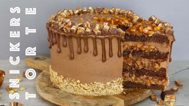 there is a chocolate cake with nuts on the top and one slice missing from it