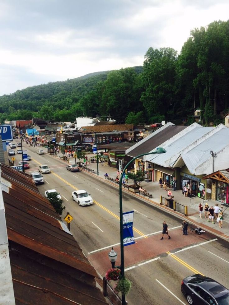 an overhead view of a city street with cars and people