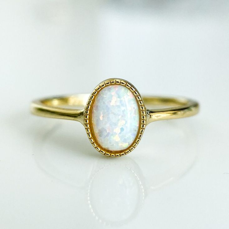 A dreamy and romantic opal ring featuring a round cut in a bezel setting and an elegant polished band in 14K gold plating over sterling silver.
A delicate vintage design and a glowing opal stone make this a truly unique piece. Vintage Wedding Rings Opal, Big Opal Ring, Yellow Gold Stackable Oval Jewelry, Oval Stackable Yellow Gold Jewelry, White Opal Birthstone Ring In 14k Gold, Oval Yellow Gold Stackable Jewelry, Adjustable White Gold Opal Birthstone Ring, 14k Gold White Opal Birthstone Ring, 14k Gold Open Ring Jewelry For Promise