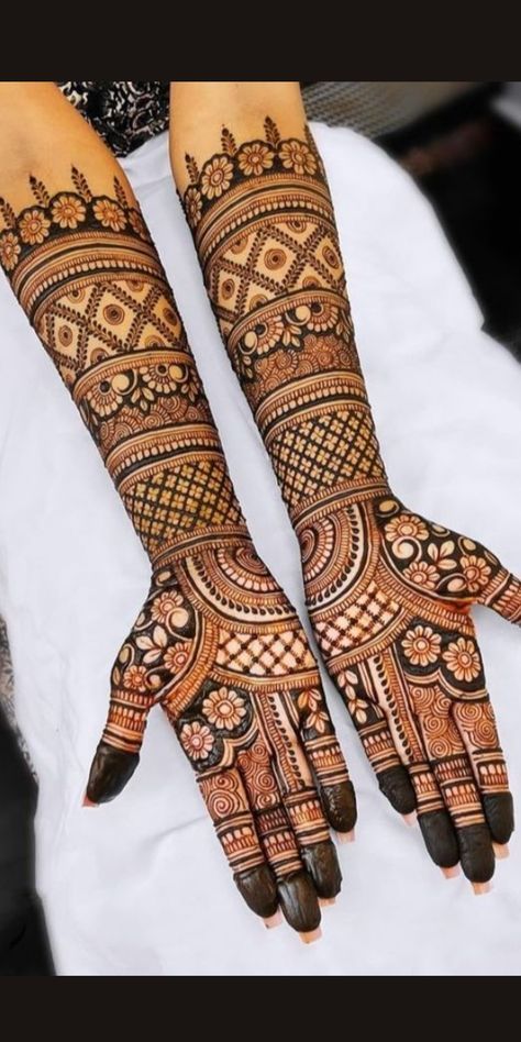 two hands with henna tattoos on them