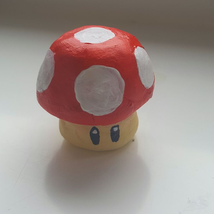 a red mushroom sitting on top of a white table