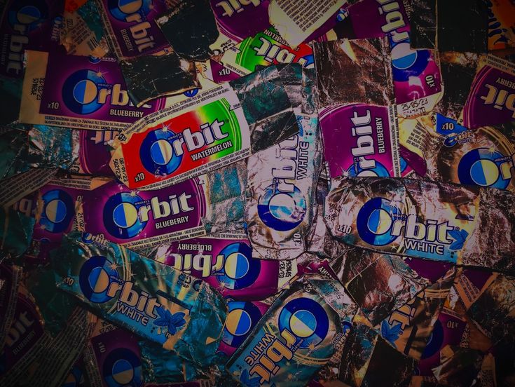 a pile of chewing stickers sitting on top of each other in front of a black background