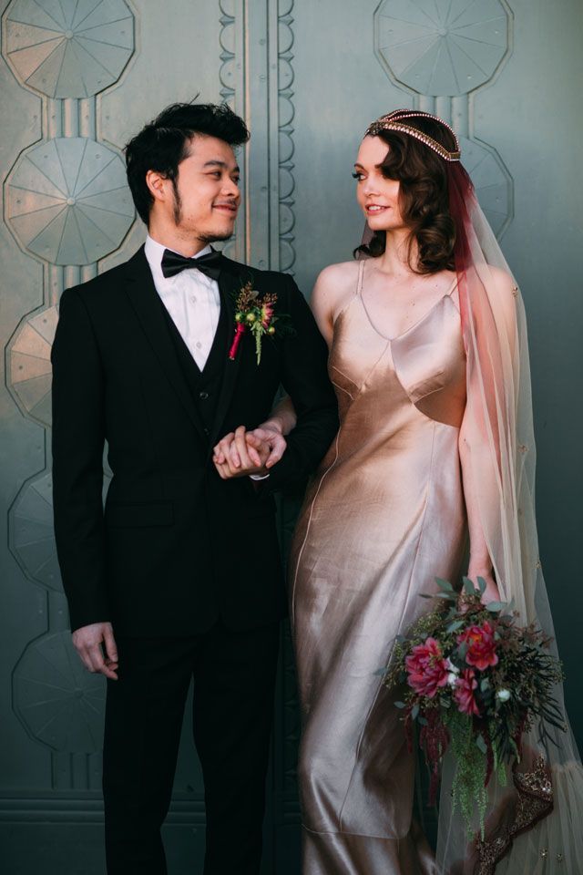 a bride and groom standing next to each other