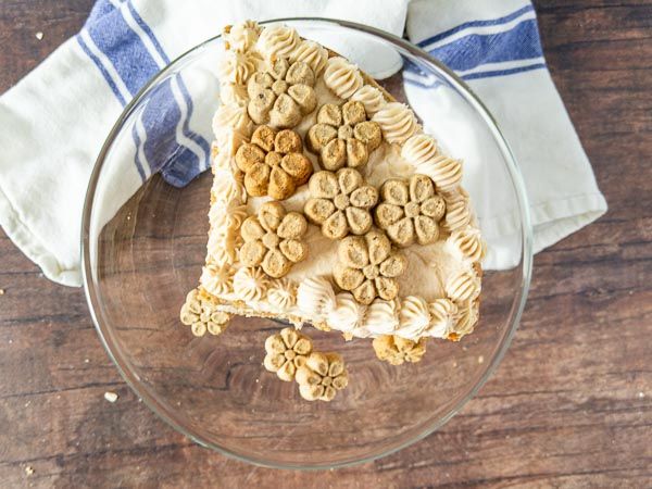 a piece of pie on a glass plate next to a blue and white dish towel