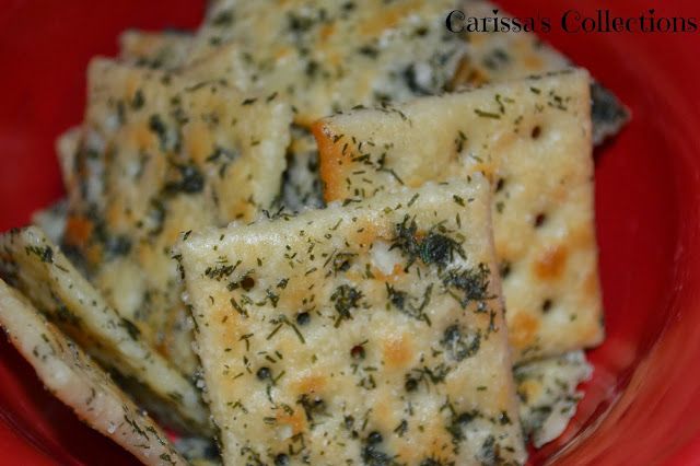 a red plate topped with cheesy crackers covered in cheese and seasoning