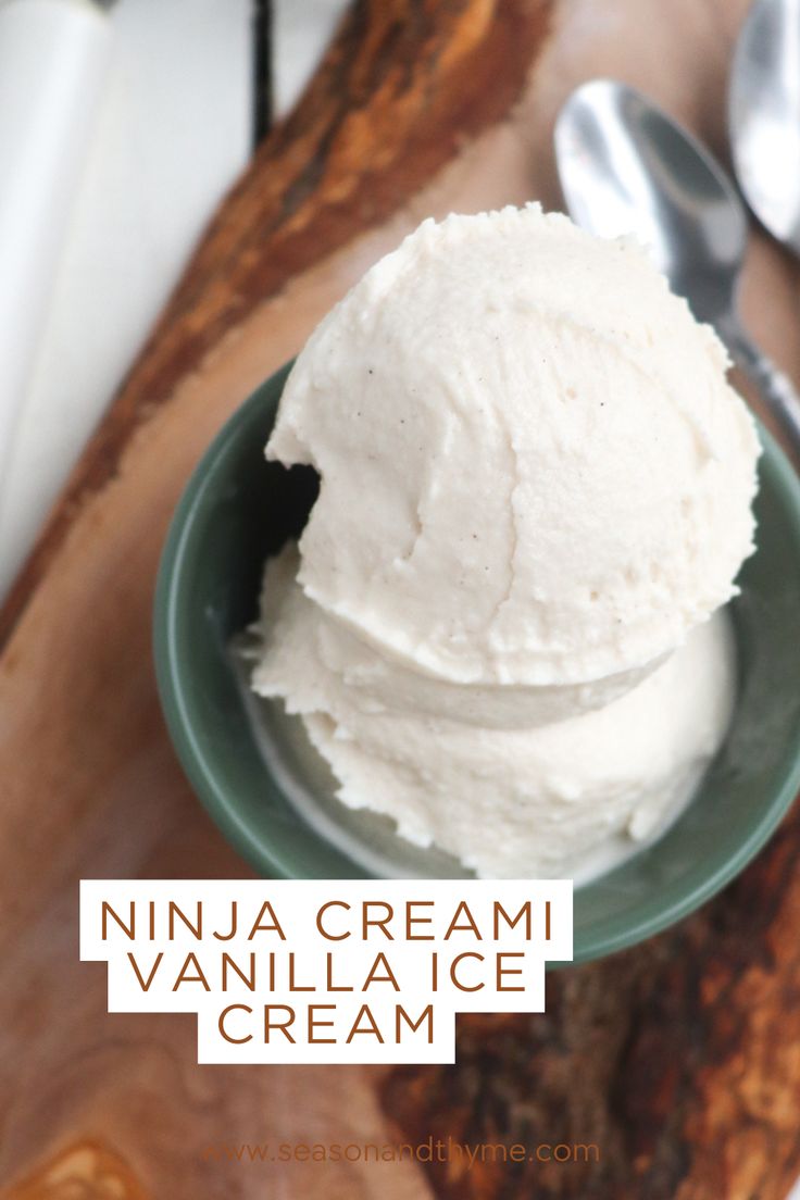 a bowl filled with vanilla ice cream on top of a wooden cutting board