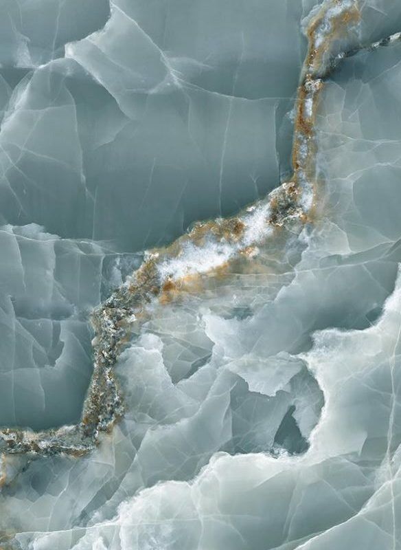 an aerial view of ice and water in the arctic with brown streaks on it's surface