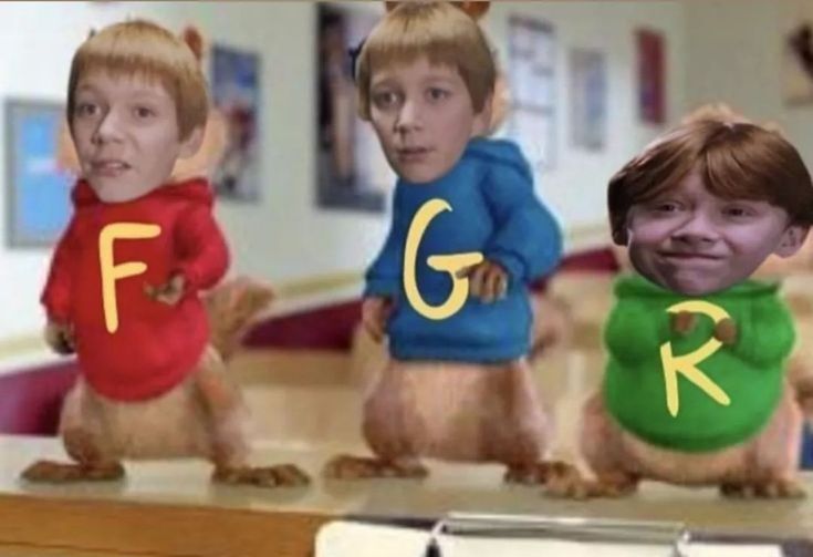 three children in sweaters with the letters f and g on their shirts, standing next to each other