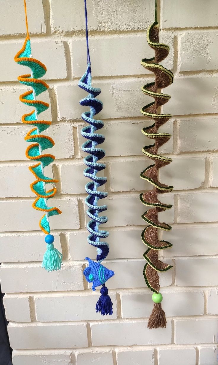 several different colored objects hanging on a brick wall