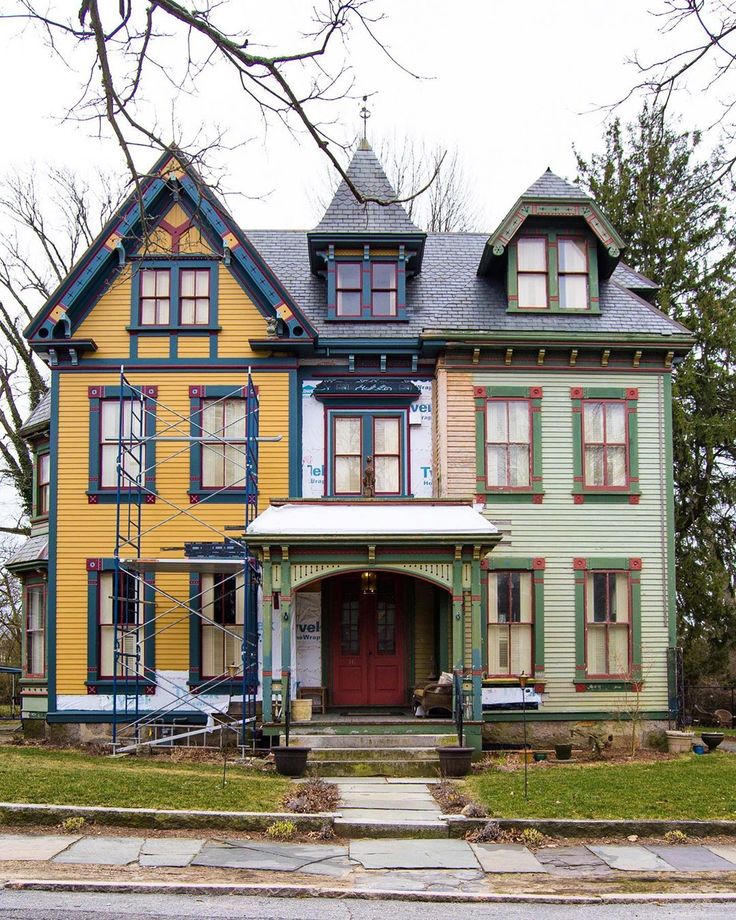 a multi - colored house with many windows on the front