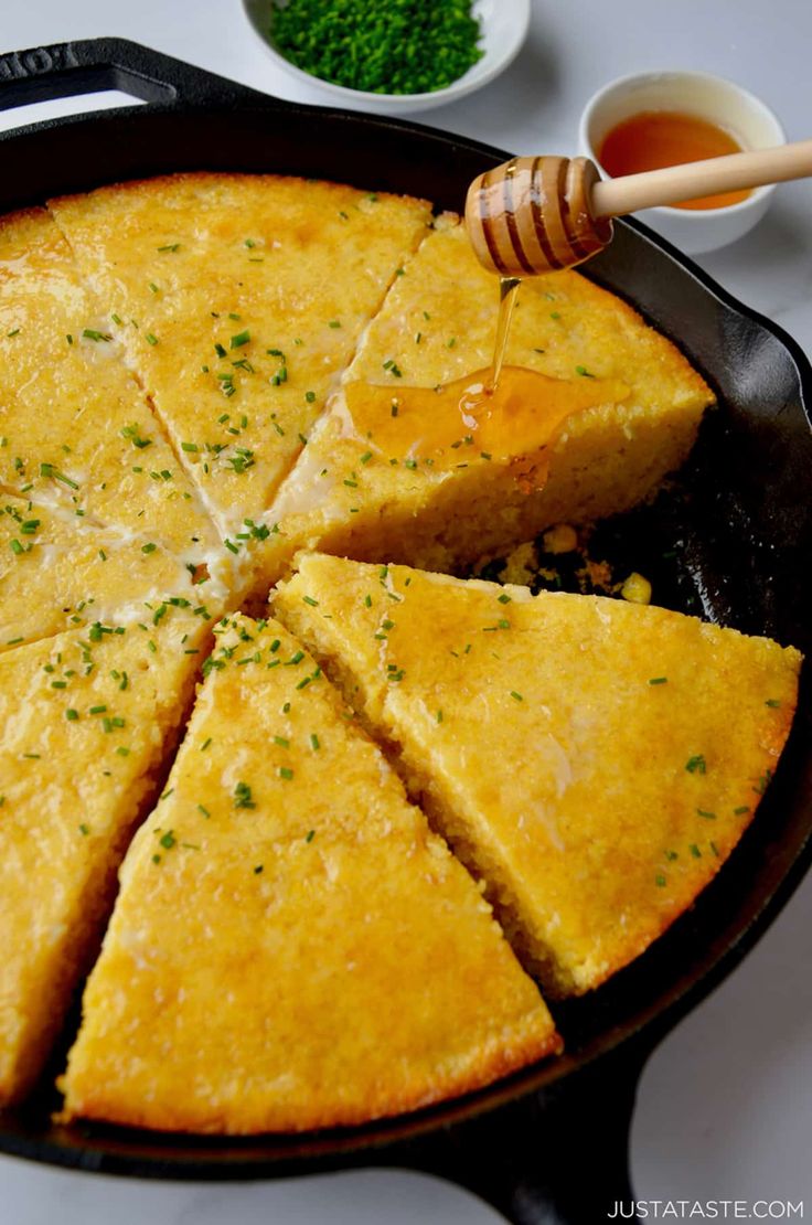 a skillet with some food in it and a honey dipper on the side