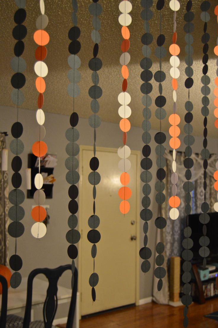 the room is decorated with black, orange and white circles hanging from the ceiling in order to make it look like they are floating