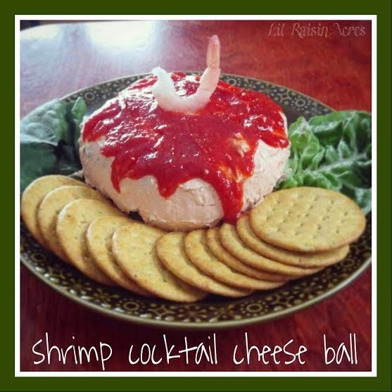 shrimp cocktail cheese ball with crackers and lettuce on a plate, ready to be eaten