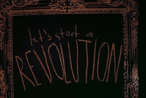 a blackboard with the words it's state of revolution written on it