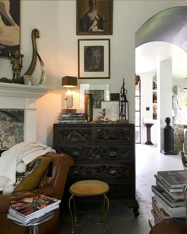 a living room filled with furniture and pictures on the wall