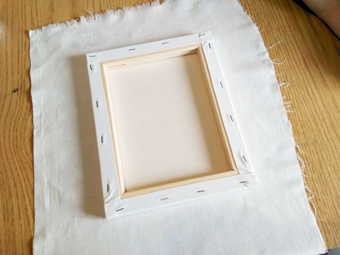 a white box sitting on top of a wooden table next to a pair of scissors