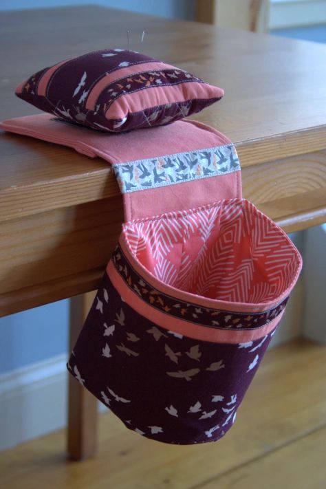 three small pouches sitting on top of a wooden table