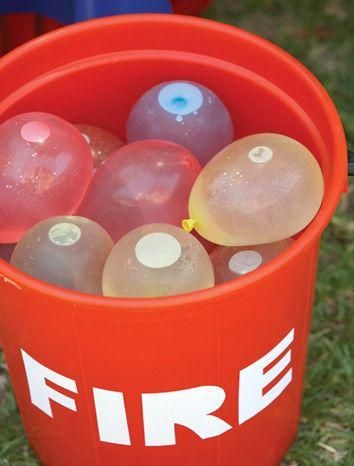 an orange fire bucket filled with plastic balls