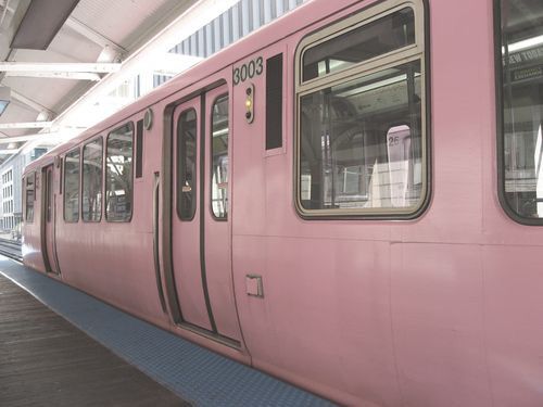 a pink train is pulled up to the station