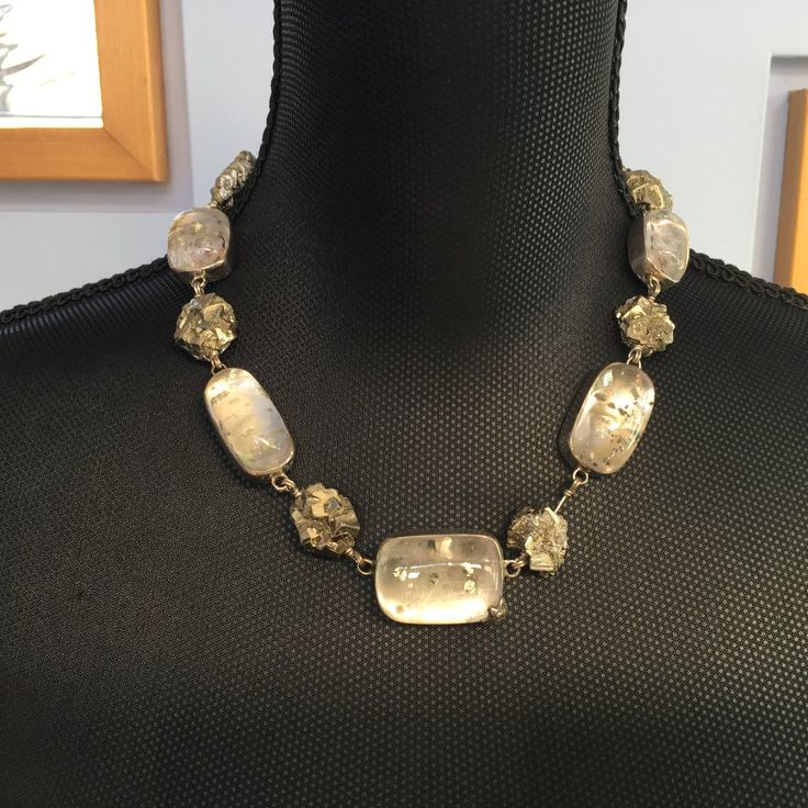 This Sterling Silver Base Necklace By Stephen Dweck Is A One Of A Kind. It Has Pieces Of Pyrite Interspersed With Rutilated Quartz. The Necklace Is Signed By Stephen And Dated. It Is 19 1/2" Long And The Largest Stone Measures Approximately 2 1/4" X 1". Luxury Glass Jewelry For Party, Silver Glass Gemstone Jewelry, Silver Glass Jewelry With Gemstone, Elegant Faceted Glass Jewelry, Unique Glass Jewelry For Formal Occasions, Elegant Glass Jewelry For Party, Formal White Glass Jewelry, Elegant Sterling Silver Jewelry With Natural Inclusions, Luxury Faceted Necklaces For Jewelry Making