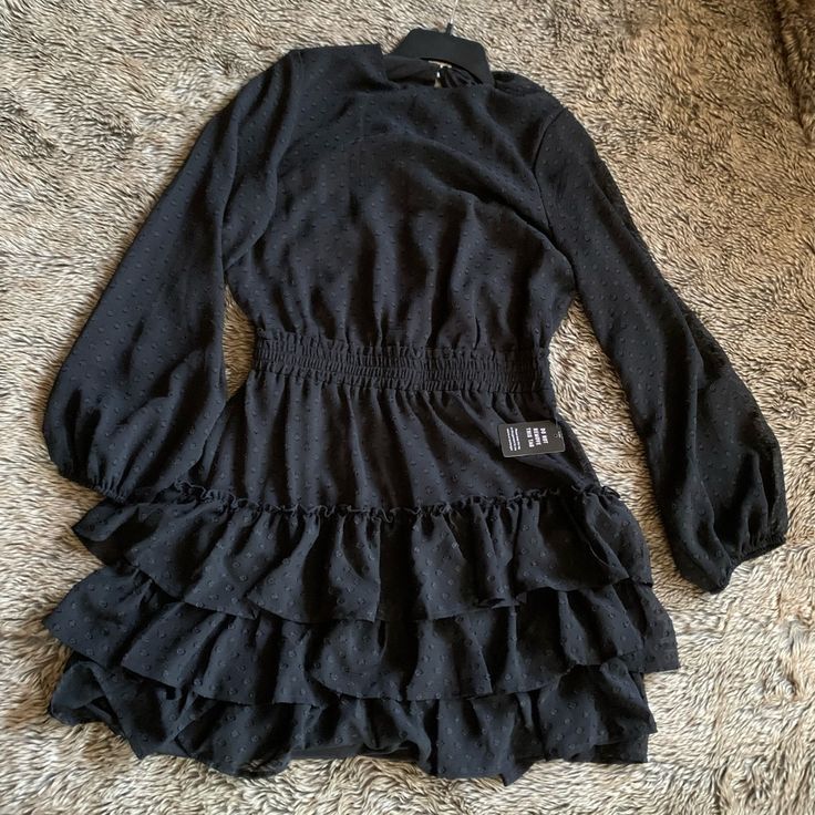 Brand New With Tags Ruffle Dress. Black. Long Bubble Sleeve. Size M Pet Smoke Free. Casual Black Ruffle Dress, Black Long Sleeve Dress With Ruffle Hem, Black Fitted Mini Ruffle Dress, Fitted Black Mini Ruffle Dress, Casual Black Ruffle Hem Dress, Winter Ruffle Dresses For Night Out, Winter Ruffle Dress For Night Out, Winter Ruffled Dress For Night Out, Winter Night Out Dress With Ruffles