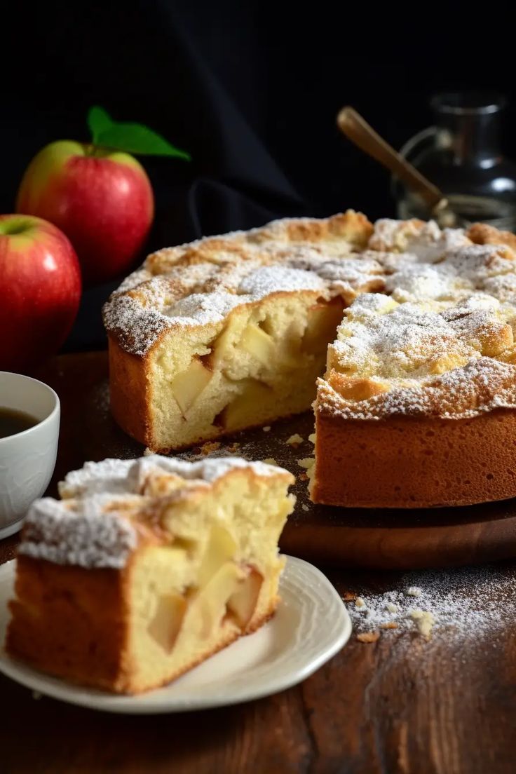 a cake with powdered sugar on top and two slices cut out