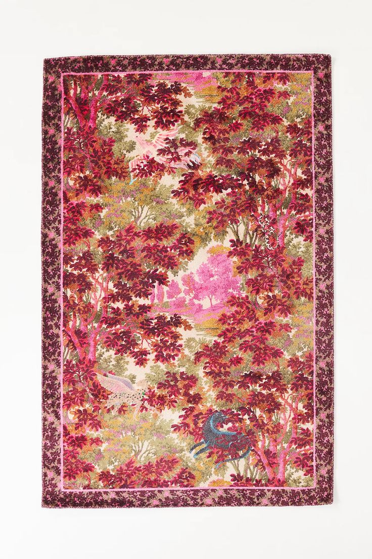 a pink and red rug with trees on it